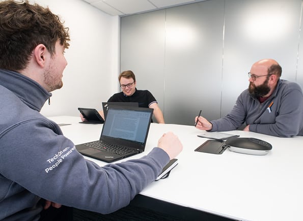 SEP2 employees talking in a meeting room