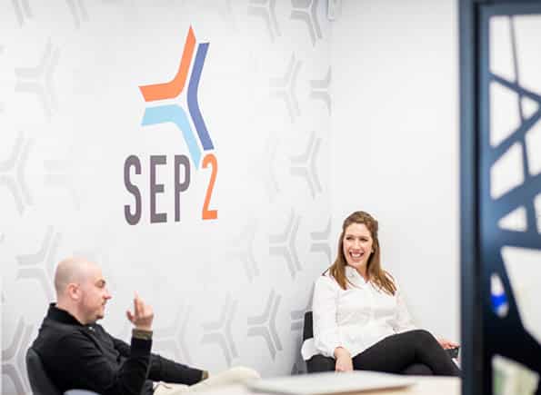 Jake & Natalie chatting in front of the SEP2 logo