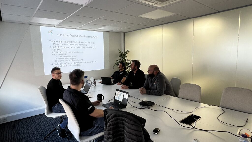 SEP2 employees in meeting room looking at a projector screen