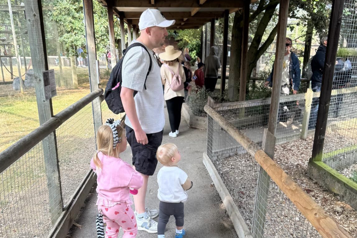 picture of a man with two children at the zoo