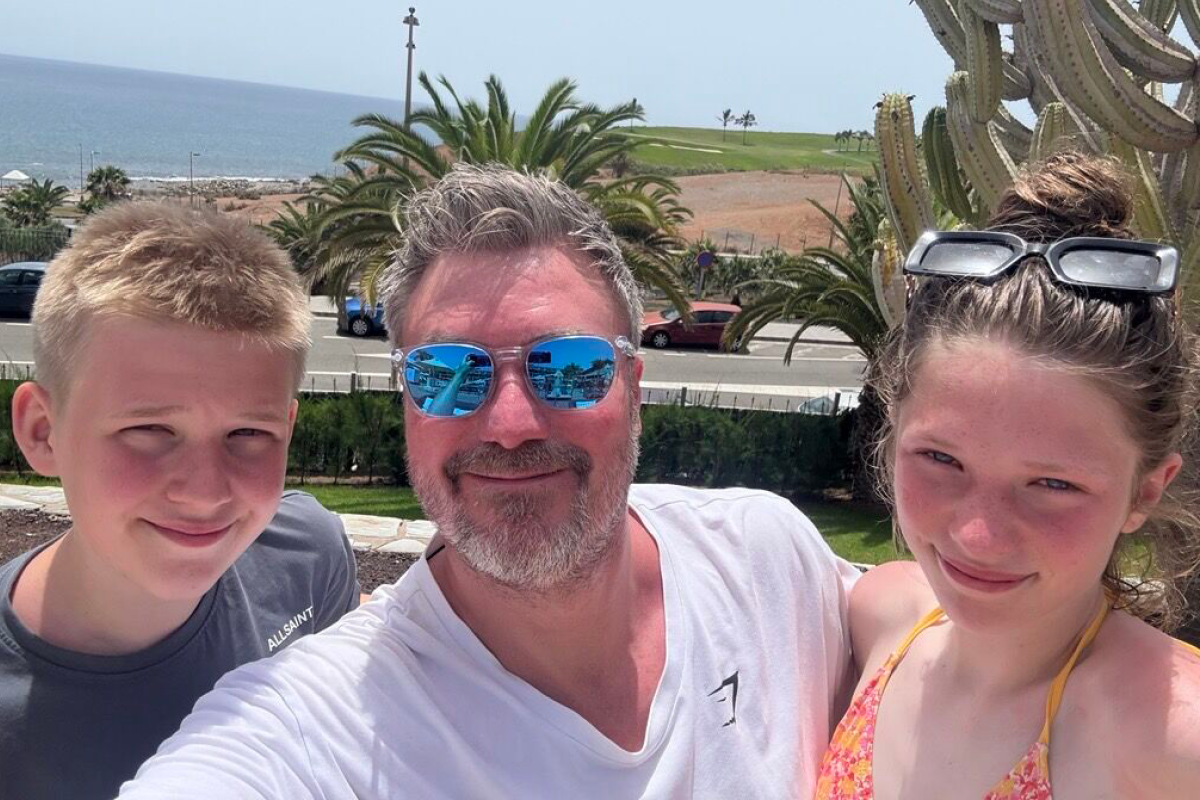 picture of three people smiling at the beach on a SEP2 4ugust day